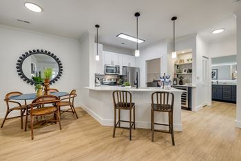 an open kitchen and dining area with a table and chairs